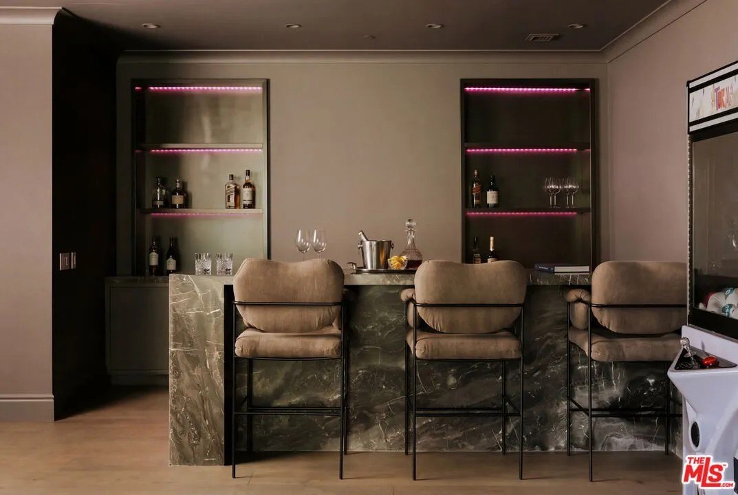 A bar with pink lighting in a home in Hidden Hills California belonging to Kylie Jenner