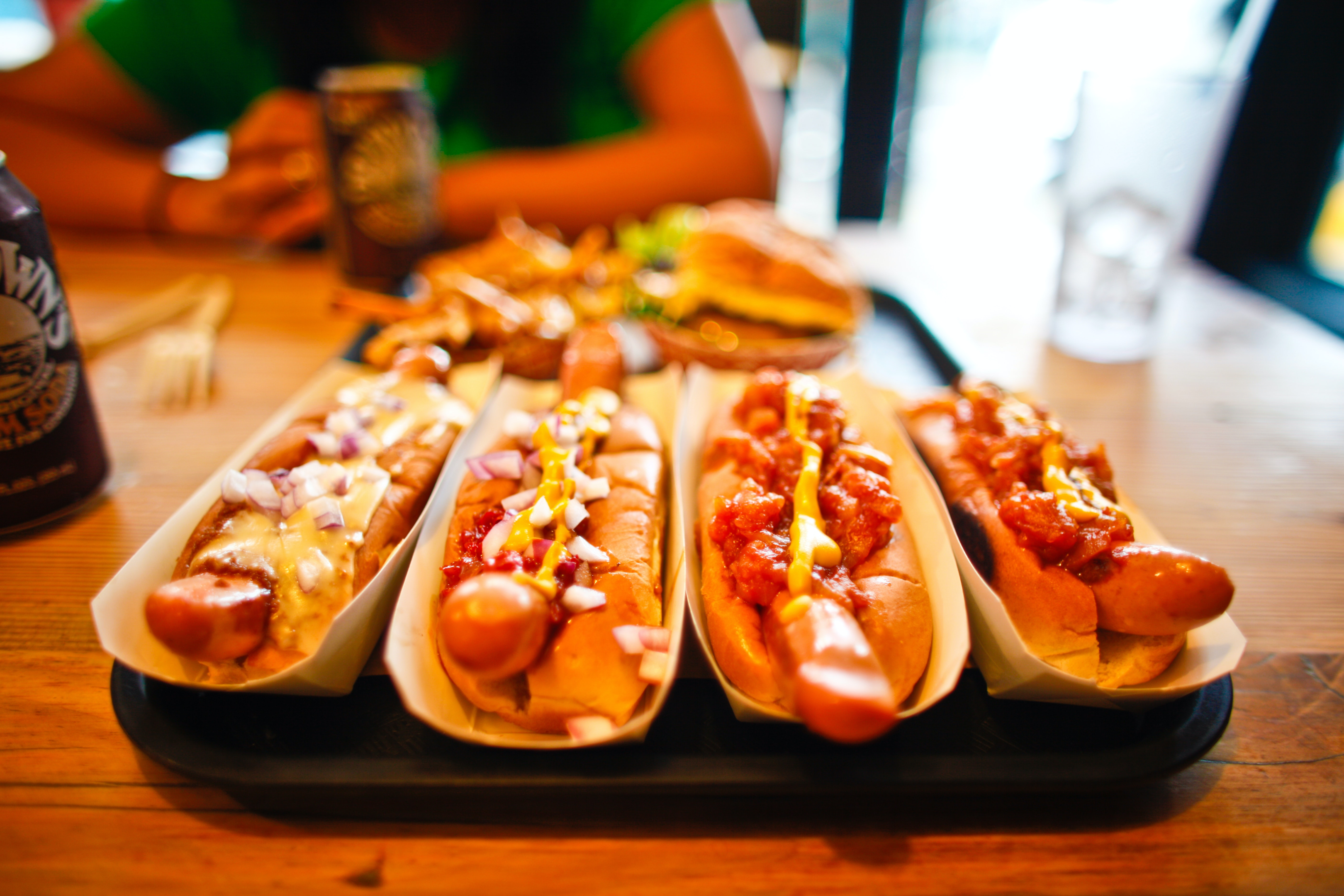 Four hotdogs with a variety of toppings