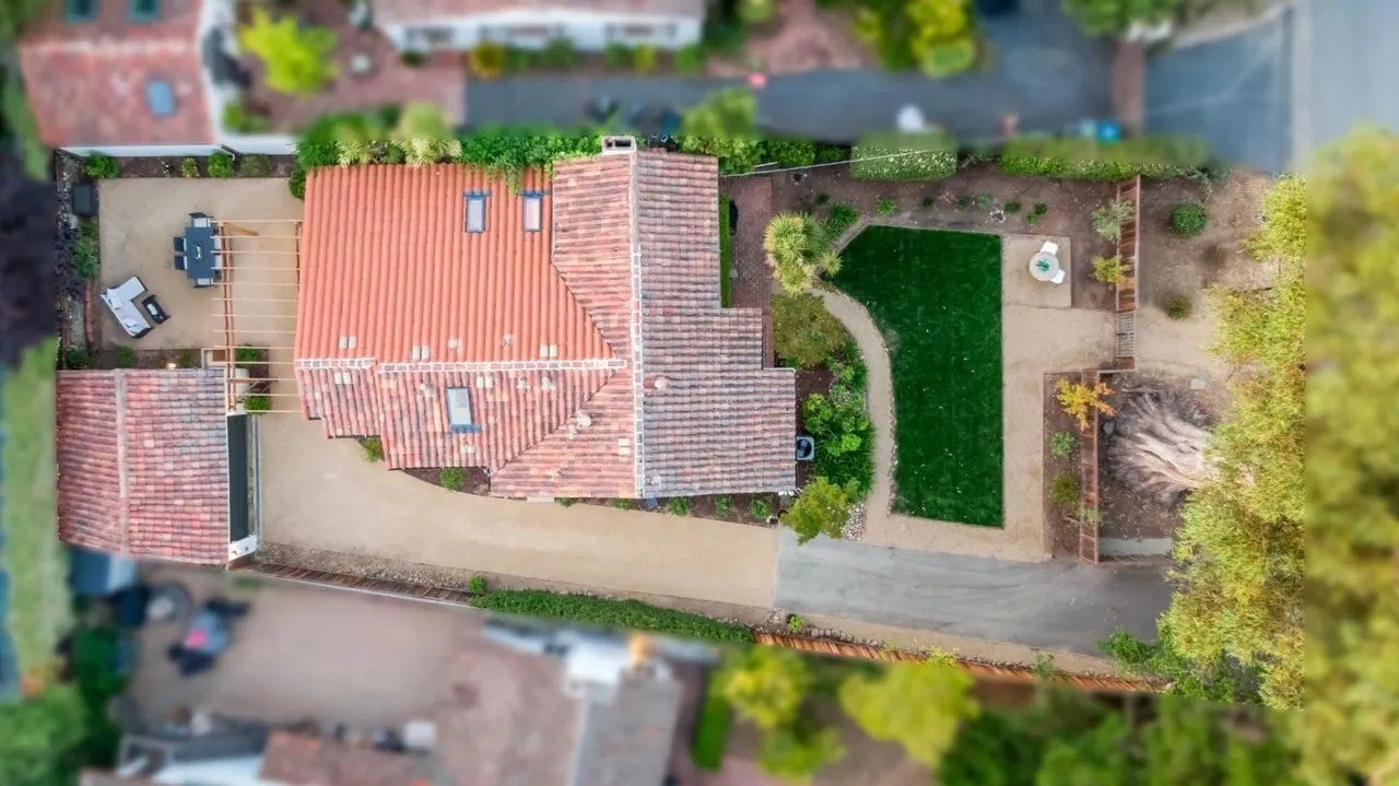Aerial view of a home, featuring no sidewalks.