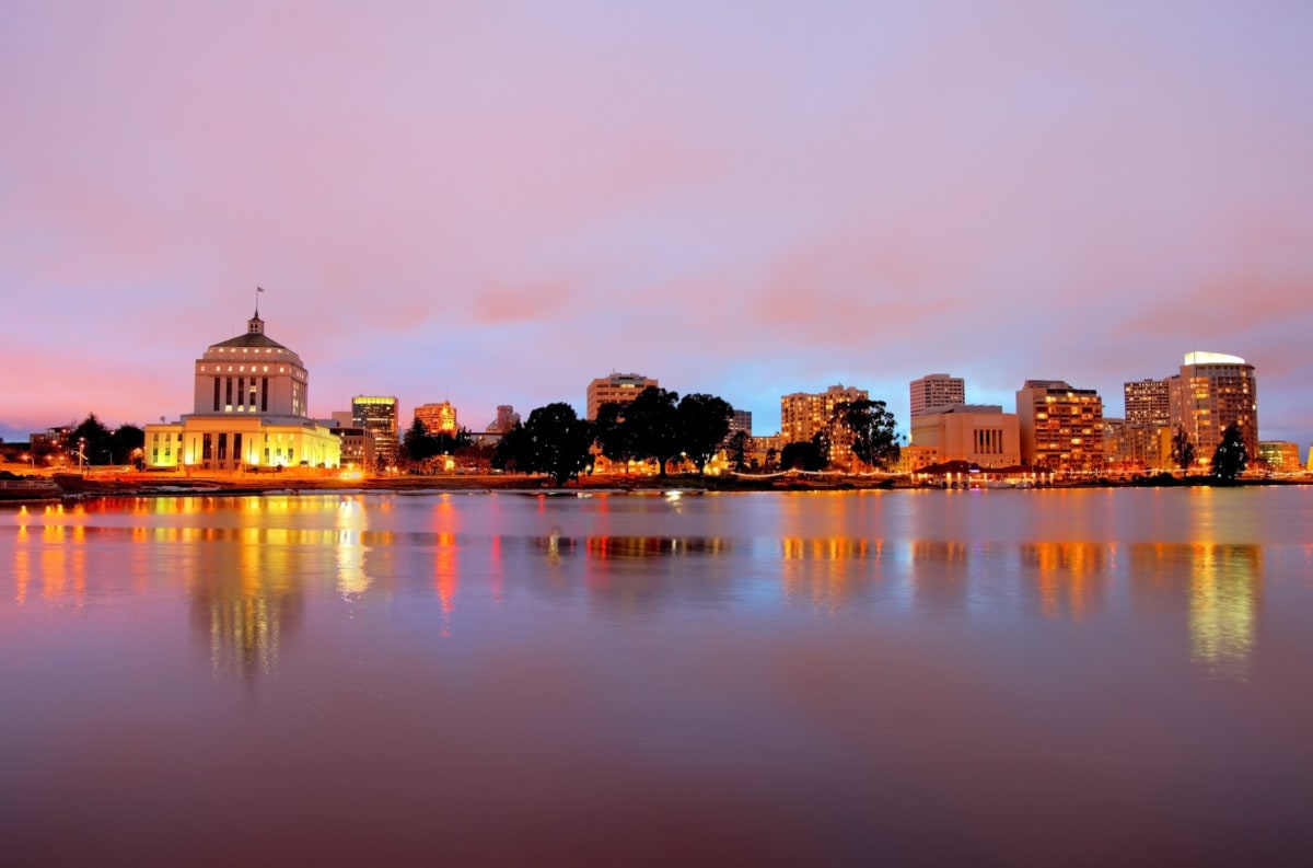 Downtown Oakland skyline along the banks of Lake Merritt at dusk