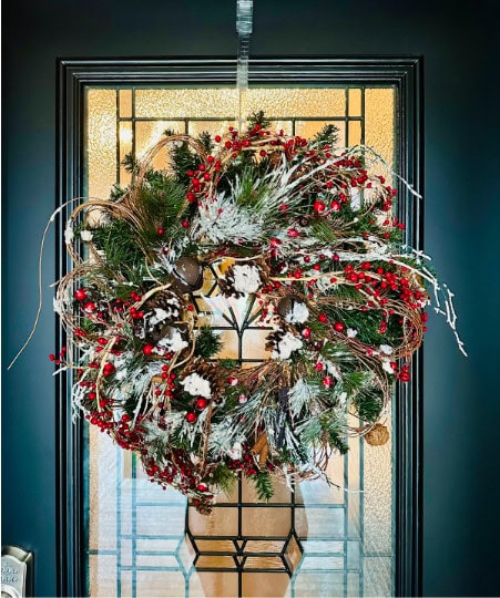 A traditional Christmas wreath with red accents