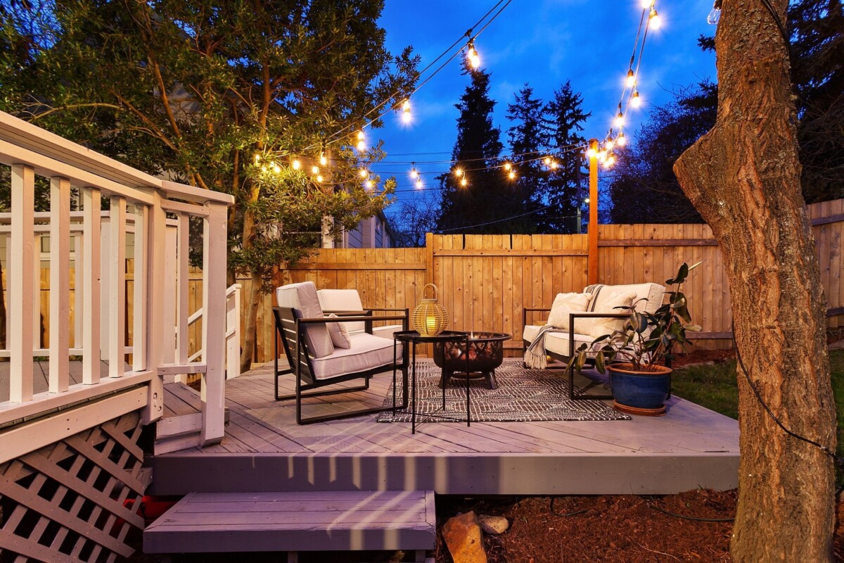 A porch with a firepit and chairs