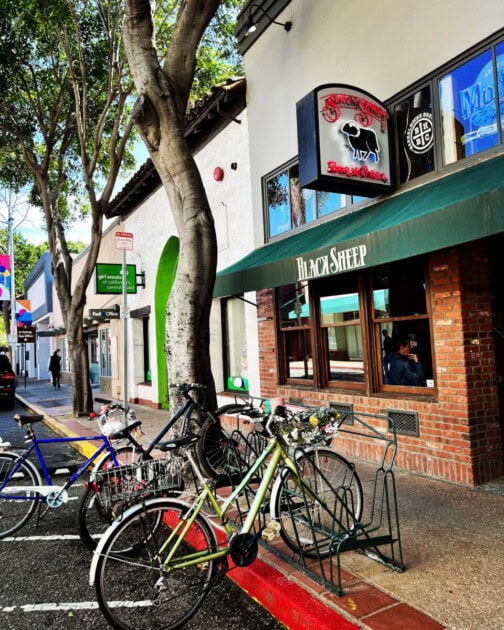 Street view of Black Sheep Bar & Grill with bikes out front, a summer to do in San Luis Obispo