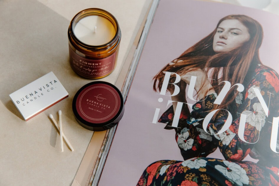 Candles with matches next to magazine with a womans face