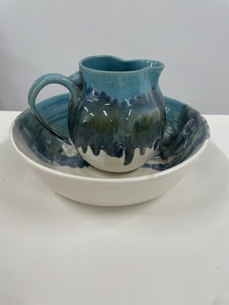 Blue clay tea mug in a clay bowl 