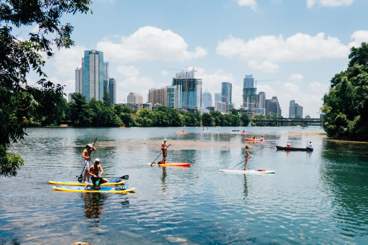 People paddle boarding on lake austin