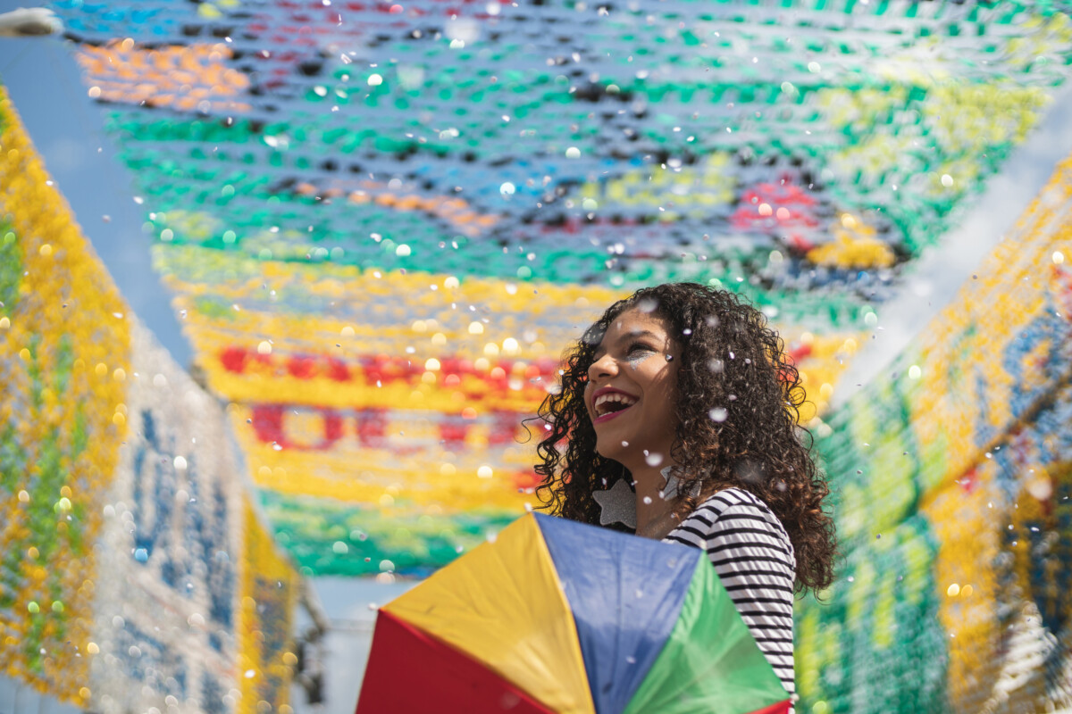 Girl at colorful cultural celebration with umbrella