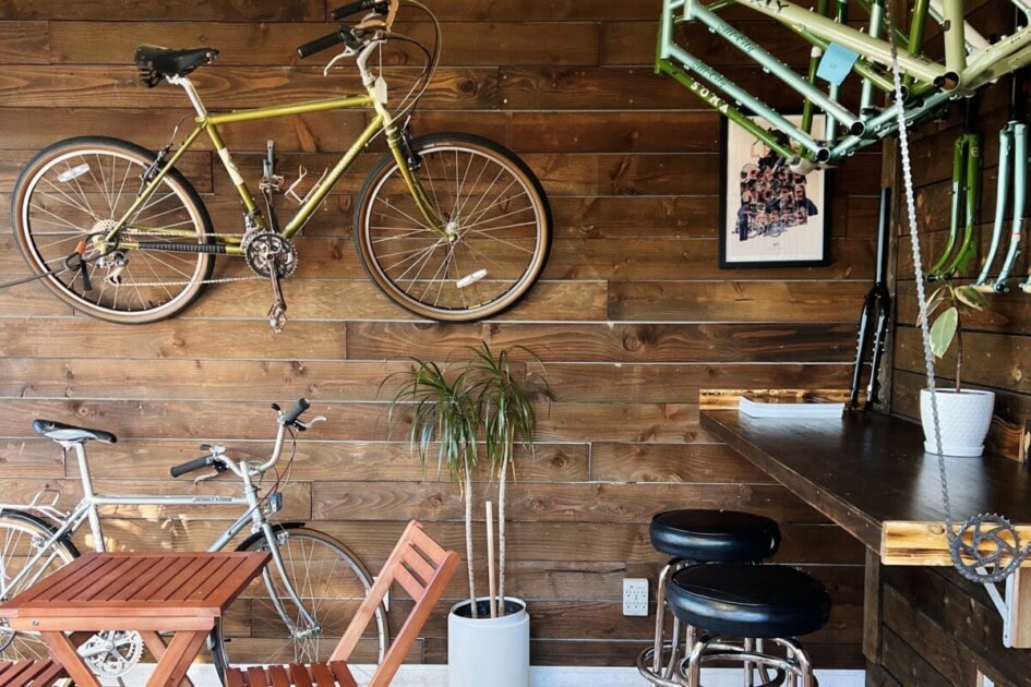 two bikes and a bike rack hang on the wooden wall of Cycle & Coffee, a great date spot in Seattle