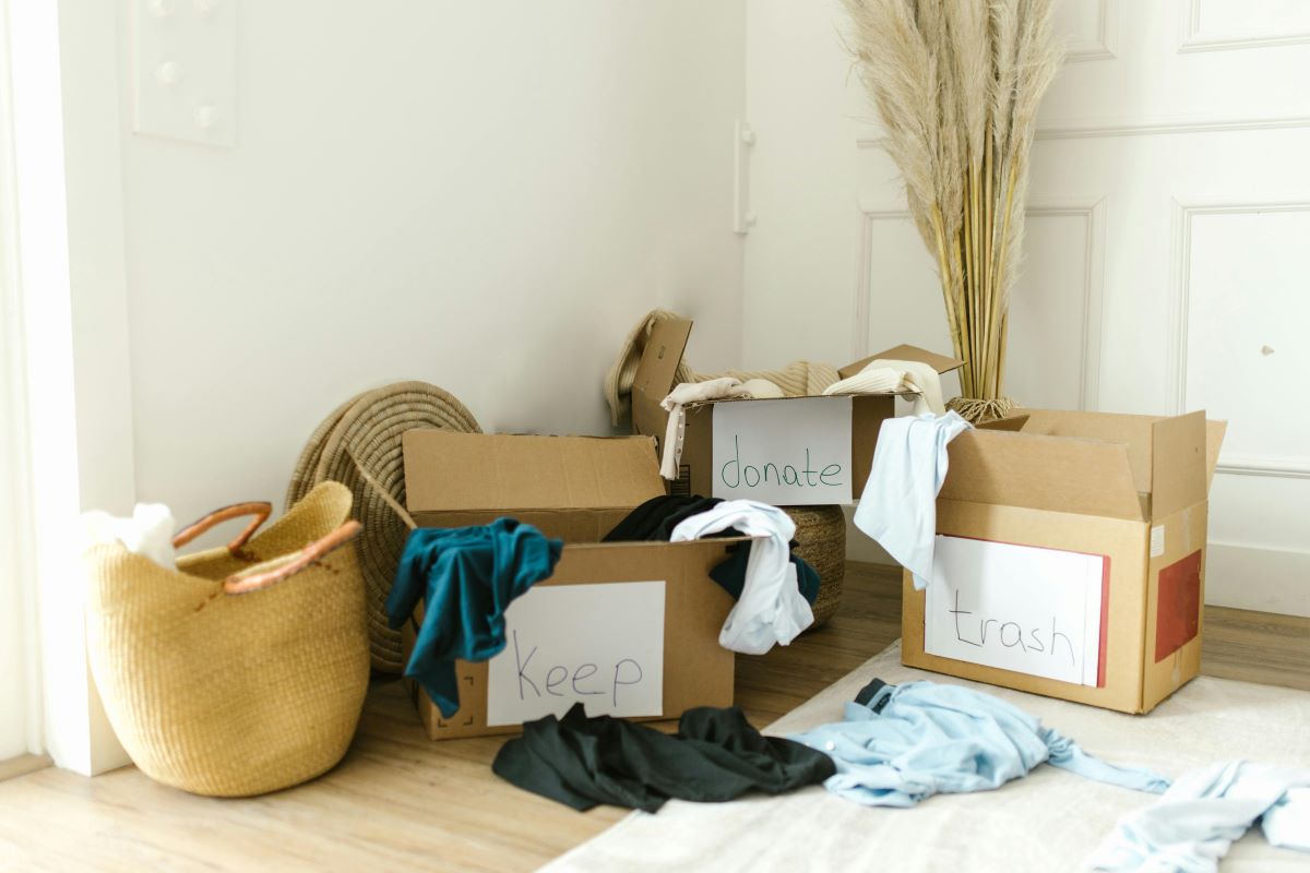 Boxes full of items to be donated and trashed using tips for moving on a budget.