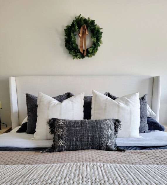A minimalist wreath design hung above a bed