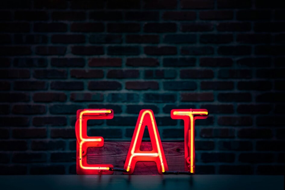 Eat sign with brick wall