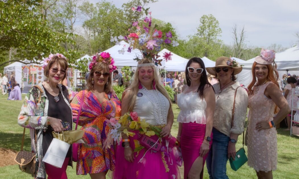 Women taking photo outside dressed with flowers as accessories