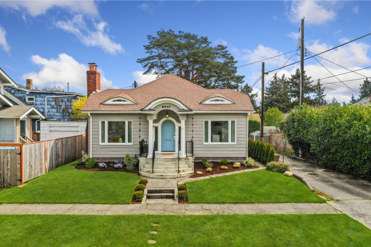 A small house with a front lawn