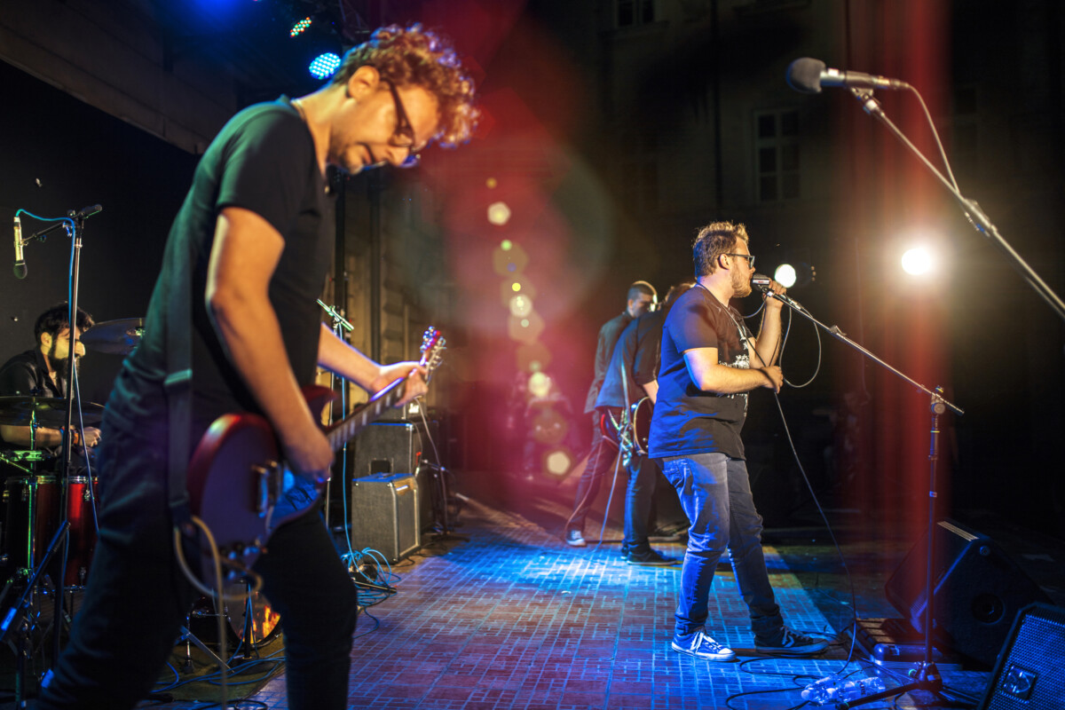 Young music band performing at rock concert