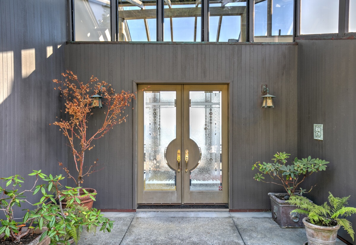 Front door entry to house: Modern, luxurious skylight home by ocean in northern California