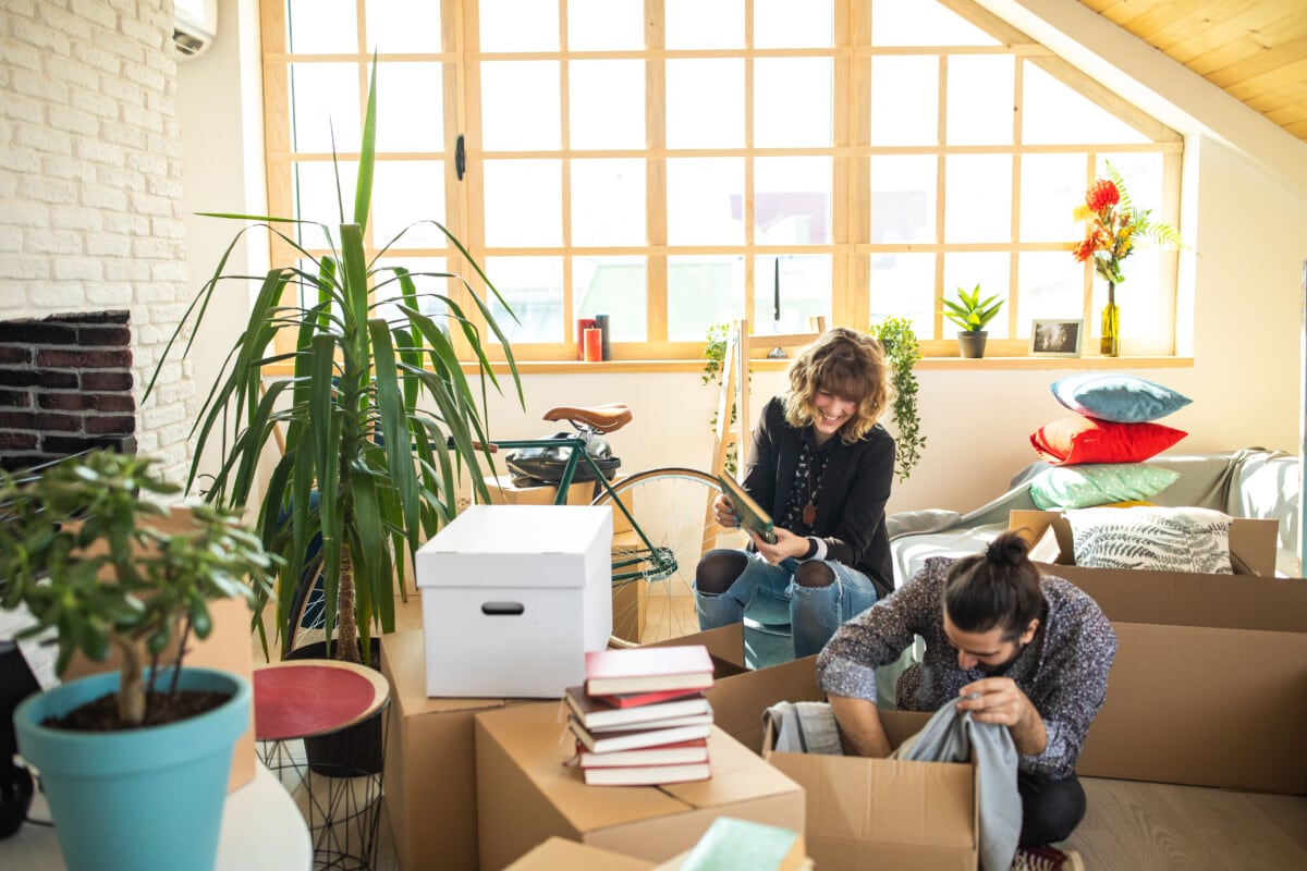 Couple packing stuffs in boxes