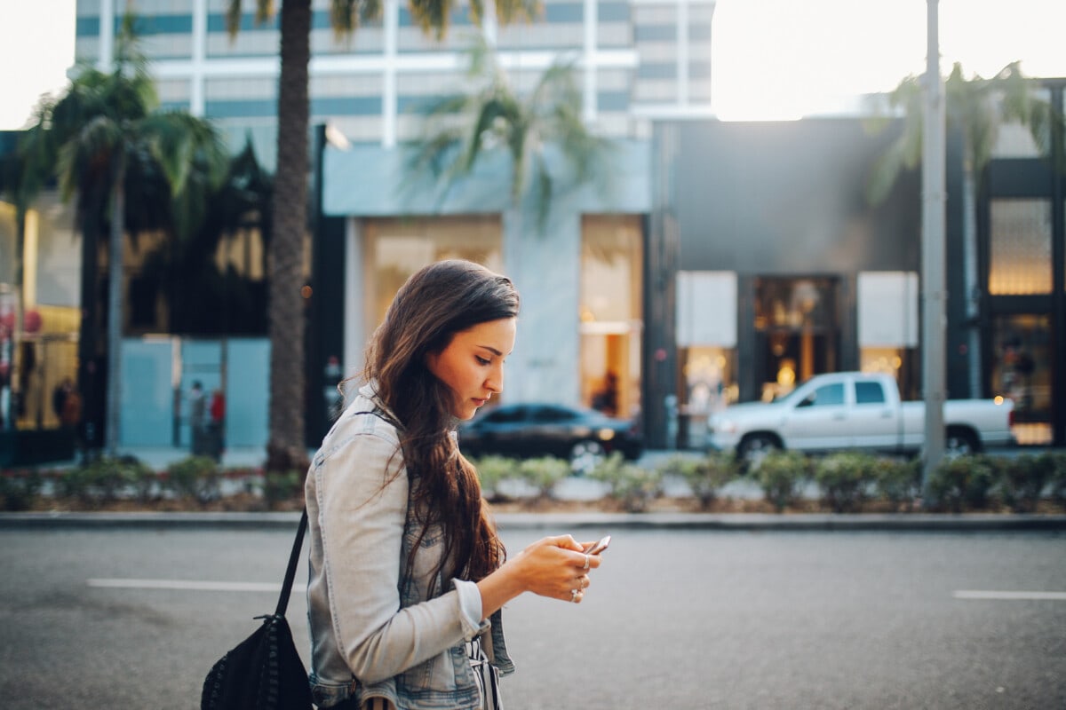 Woman on her phone while walking through Beverly Hills,CA