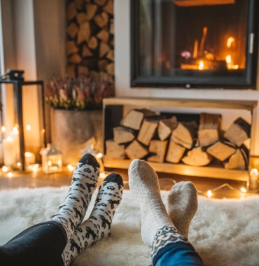 two people near a fireplace