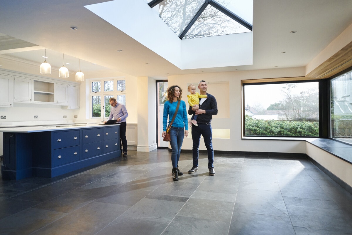 Family looking around a house with an estate agent.