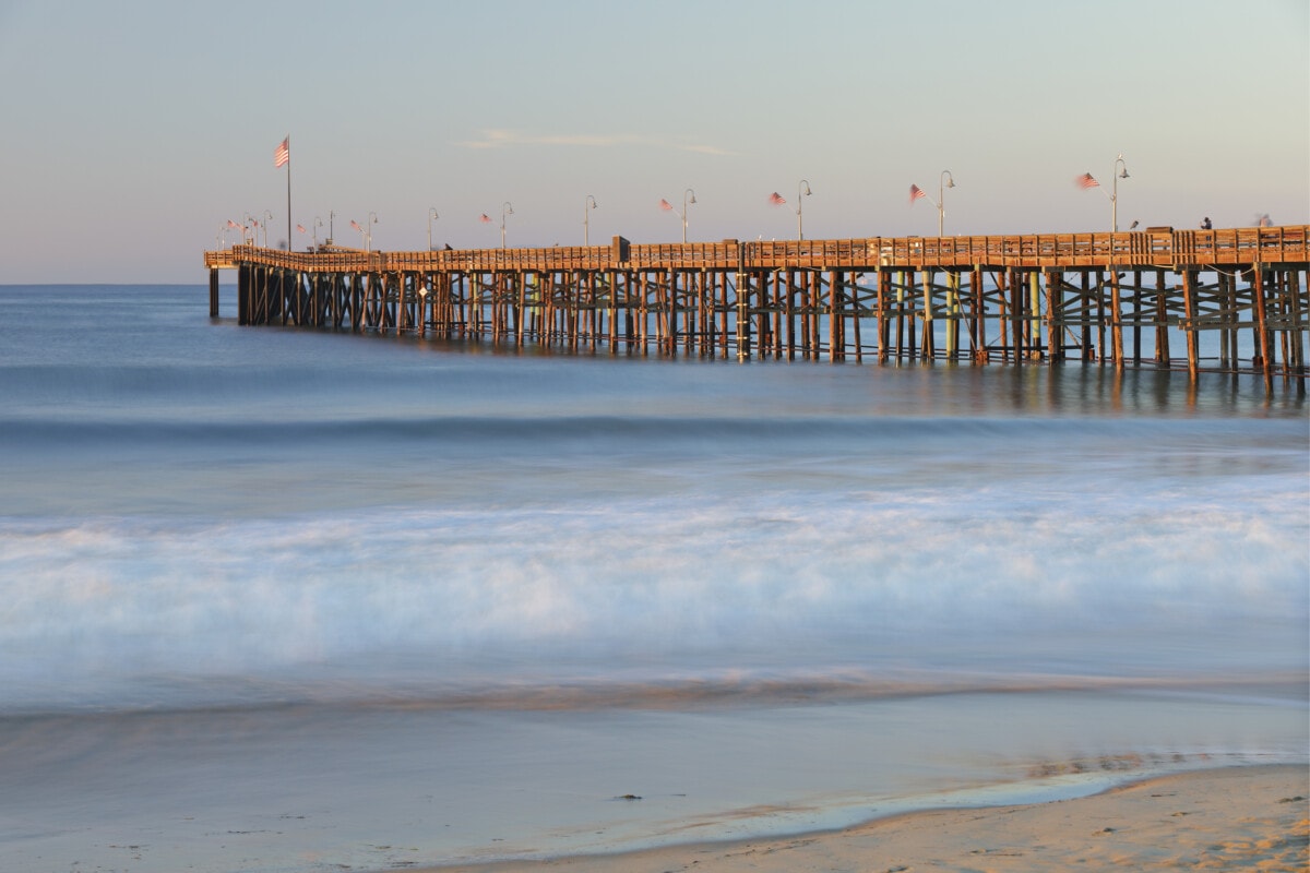 Long exposure view of Ventura Pier and the Pacific ocean at sunrise (Ventura County, California).