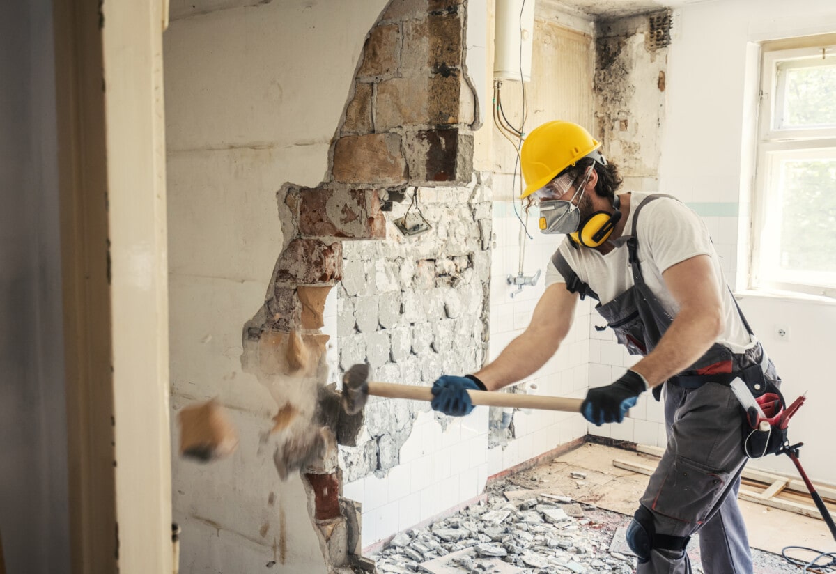 Worker using hammer, home renovation