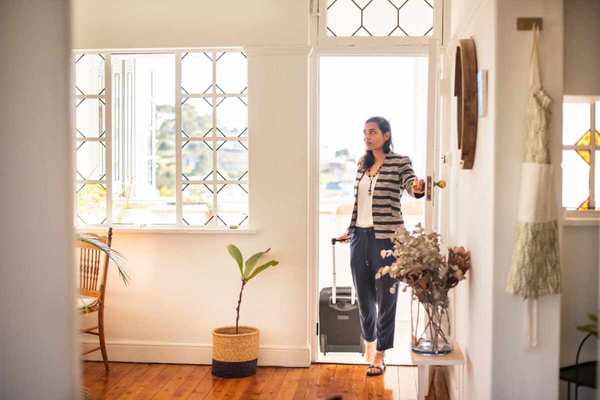 woman with a suitcase arriving at her vacation rental accommodation