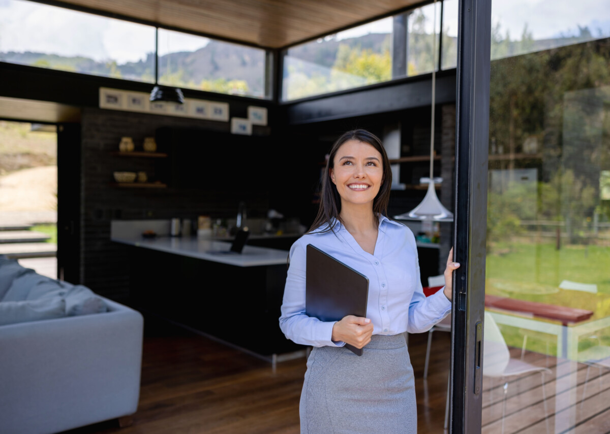 Happy real estate agent showing a property