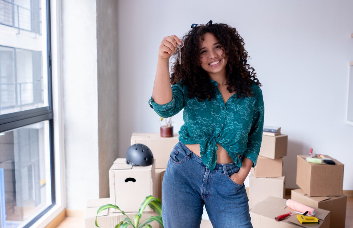 woman holding keys to new apartment _ getty