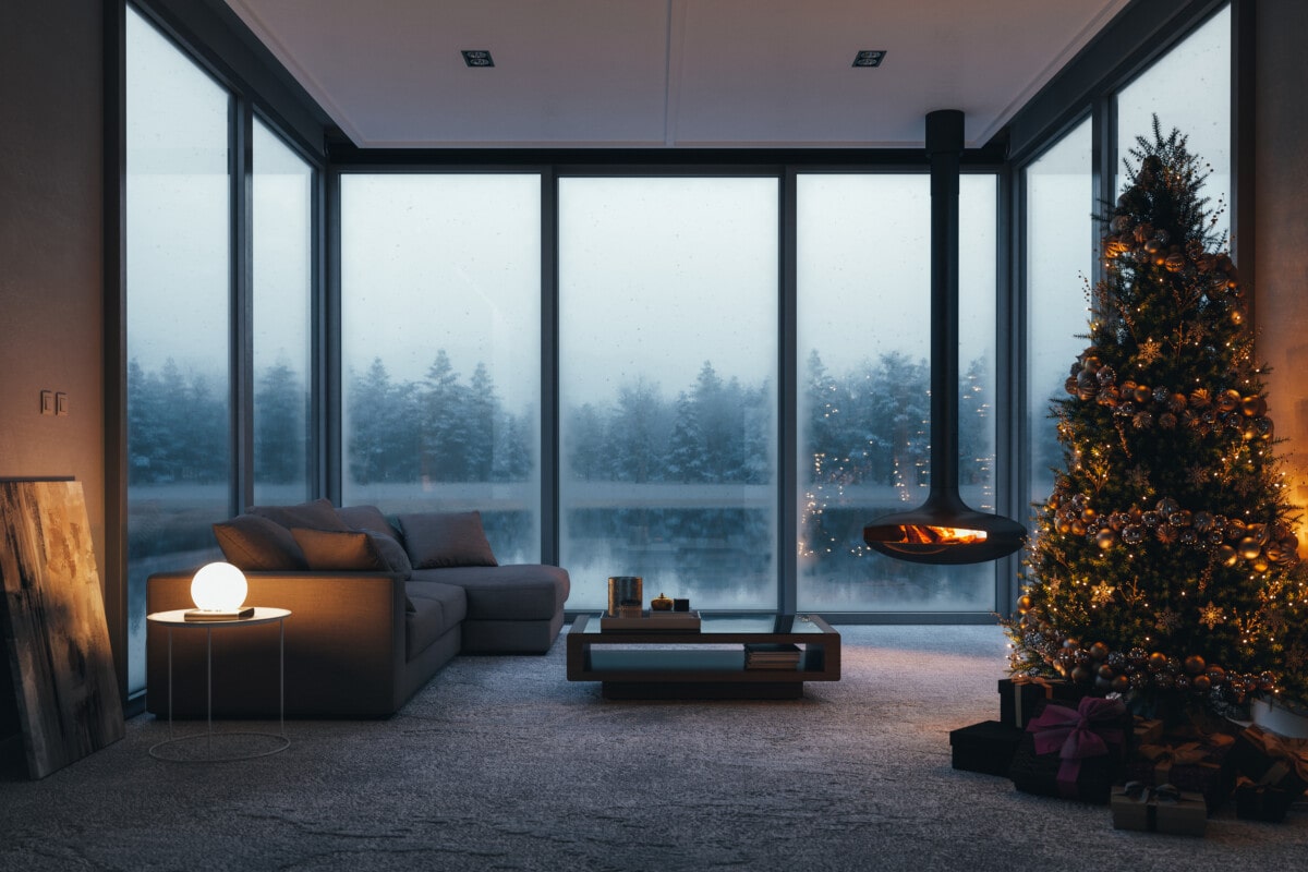 Interior of a modern lake house with fireplace and Christmas decorations in the winter.