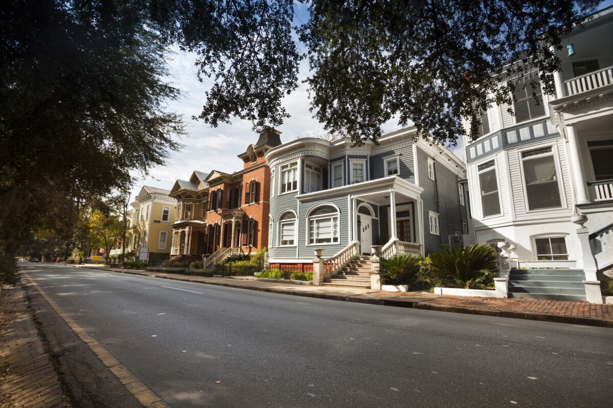 Tree lined historic homes on the community road in Savannah Georgia