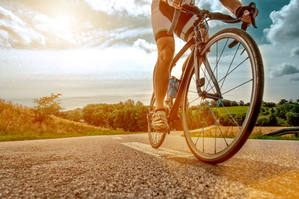 Cyclist rides his bike up a steep hill