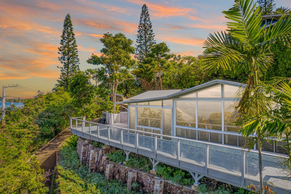 Grey house with lots of windows using solar tint