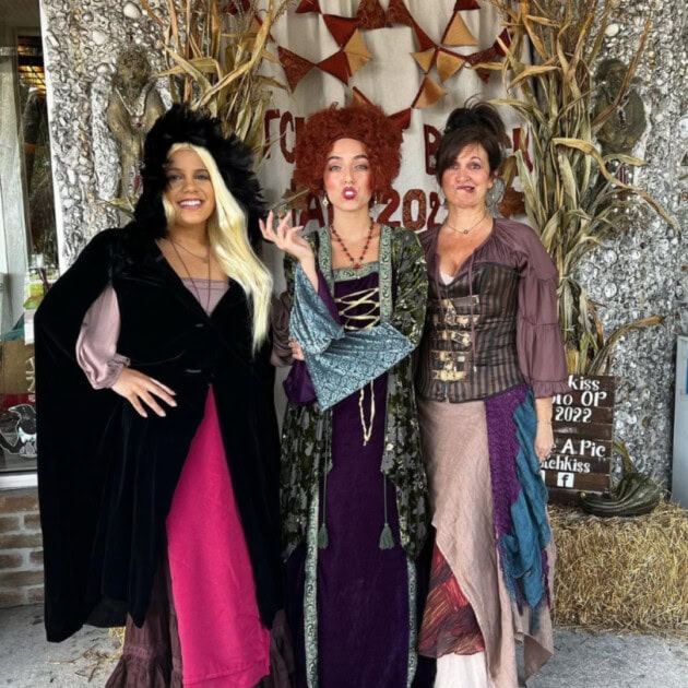 Three women dressed up in costumes