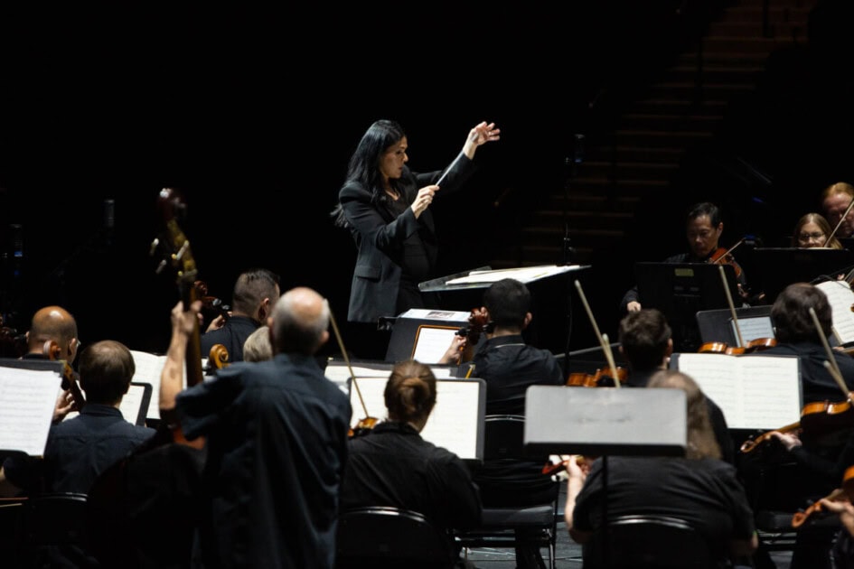 An orchestra of string instruments is conducted by a female at Henderson Symphony Orchestra this holiday season in Las Vegas, NV