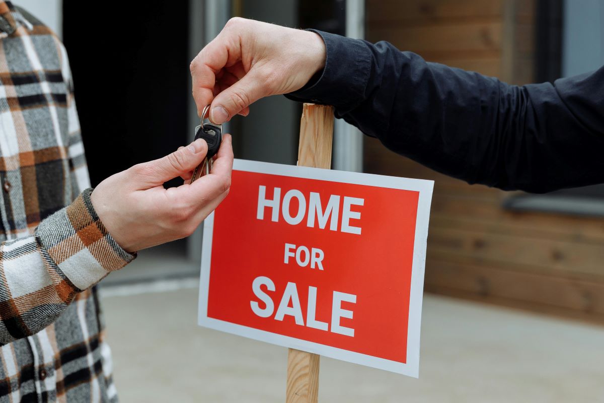 Picture of home being sold with keys handed over to the buyer