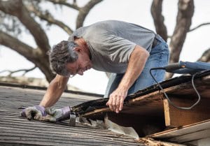 An inspector looking at a roof in need of repair