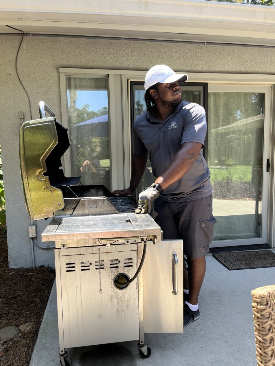 Hilton worker doing maintenance on BBQ