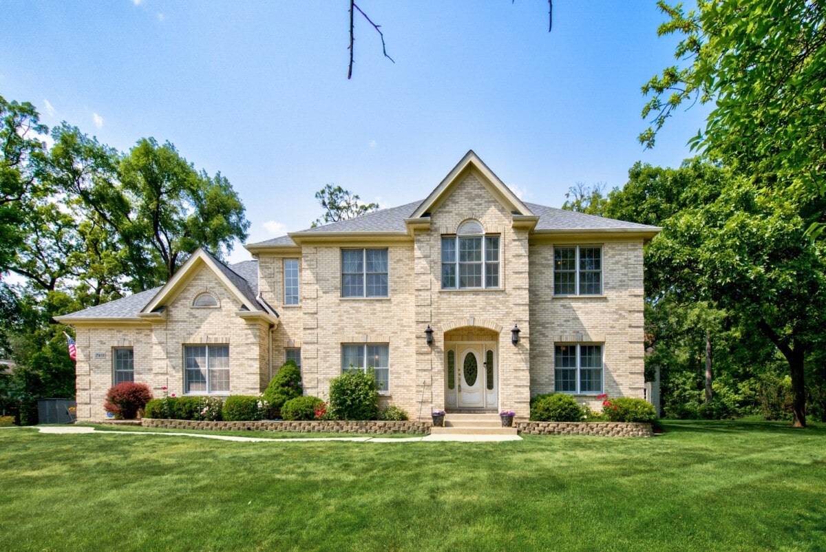 stone mansion in michigan with lush greenery