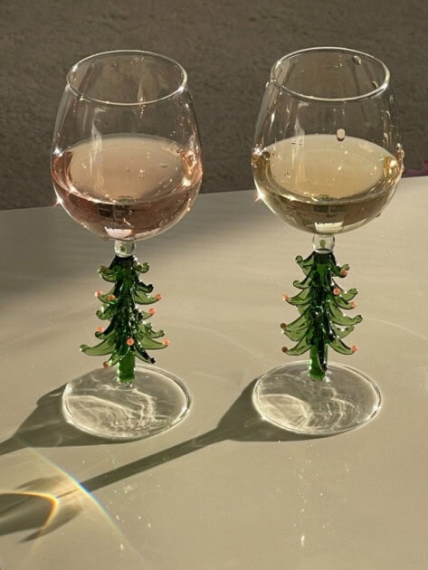 Two filled Christmas tree designed wine glasses