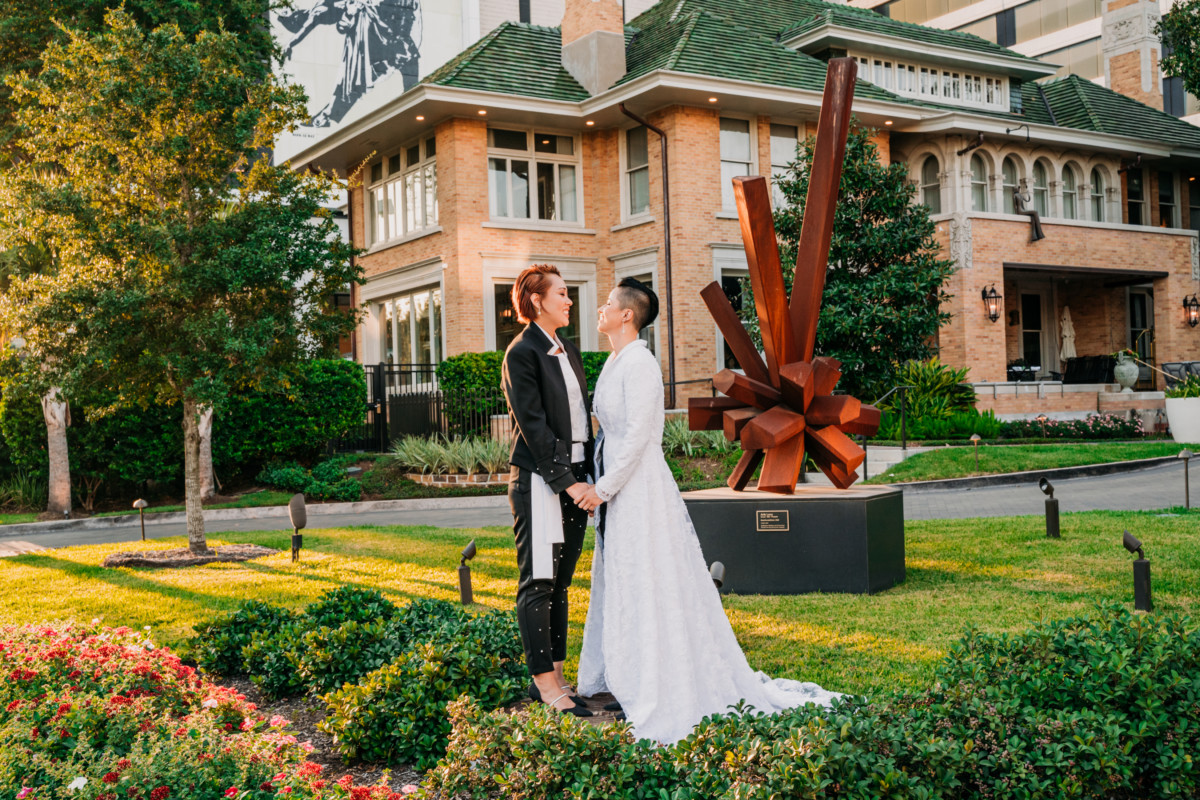 Couple embracing in front of hotel