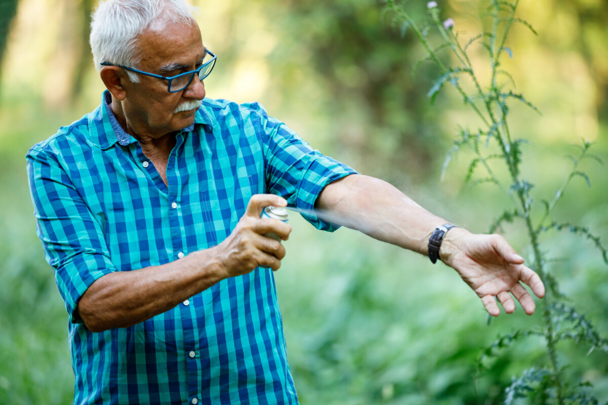 person applying bug spray