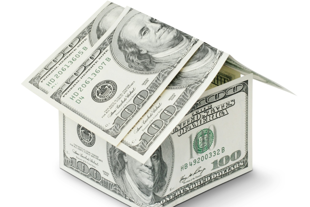 "alt_text": "A small house constructed entirely out of one hundred dollar bills, suggesting the financial aspect of homeownership. The roof is made of two overlapping bills, and the walls are formed by several bills arranged to create a cube shape. The image is set against a plain white background.", "keywords": [ "closing costs", "pay cash", "house", "real estate", "cash purchase", "home buying", "fees", "mortgage-free", "property"