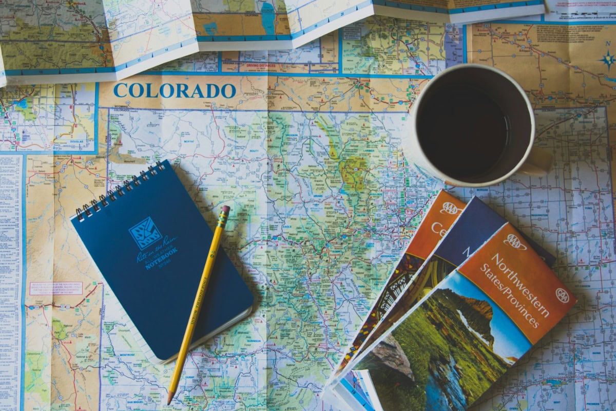 Overhead view of Colorado map with pencil and other equipment