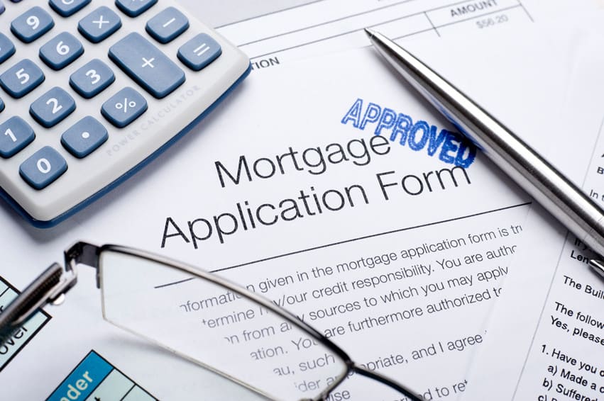 person using a mortgage application calculator on a laptop at home
