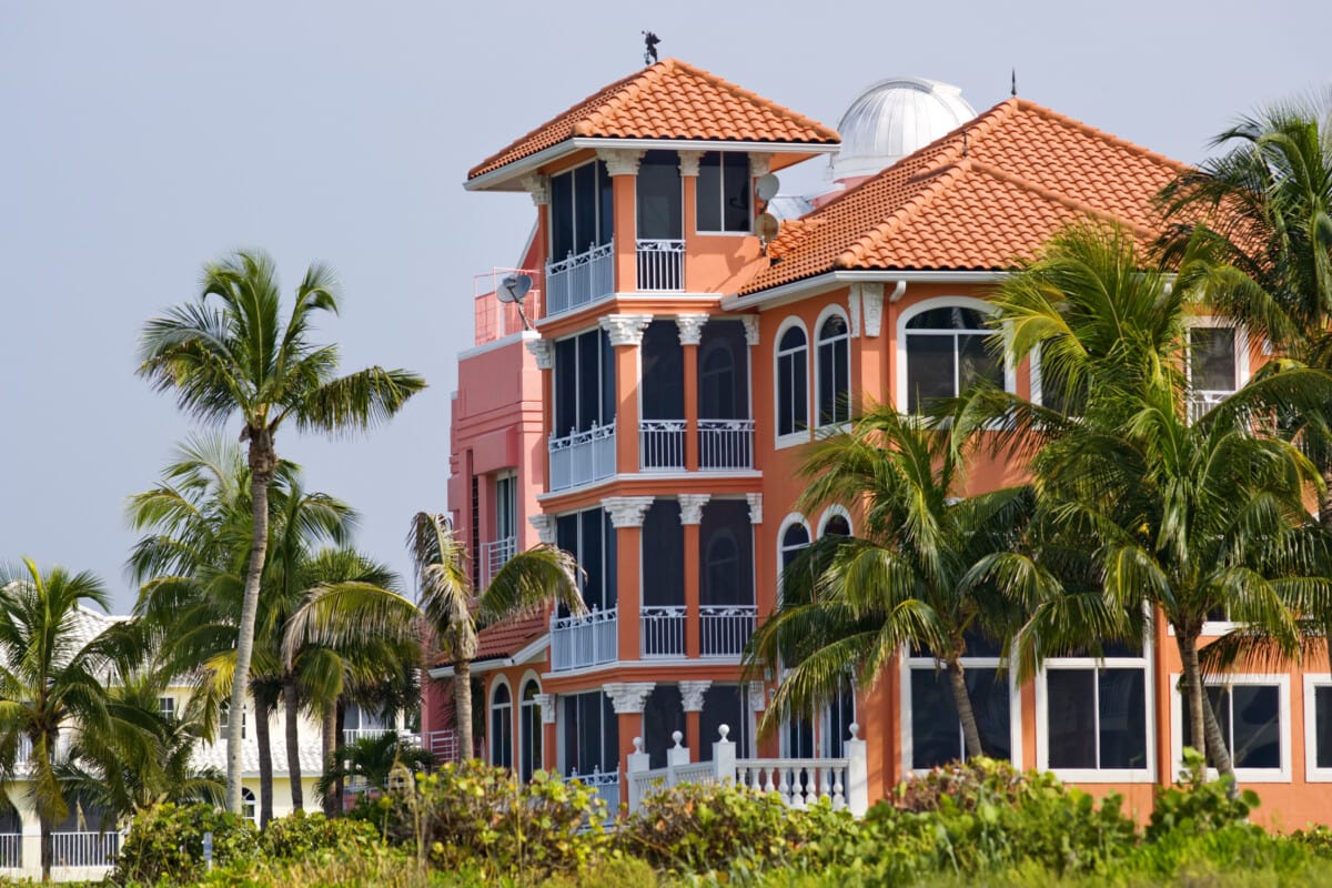 coral building with palm trees in naples_Getty