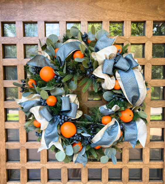 A holiday wreath using orange fruits.