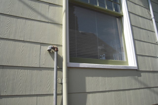 underground oil tank breather tube outside of a house