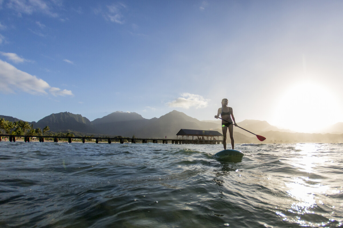 Woman Paddle Boarding in the Sun 