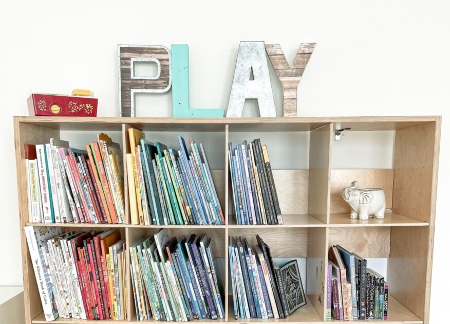 A children's collection of books color coordinated by the spine of the book