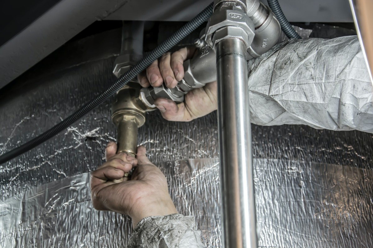 Plumbers fixing pipes